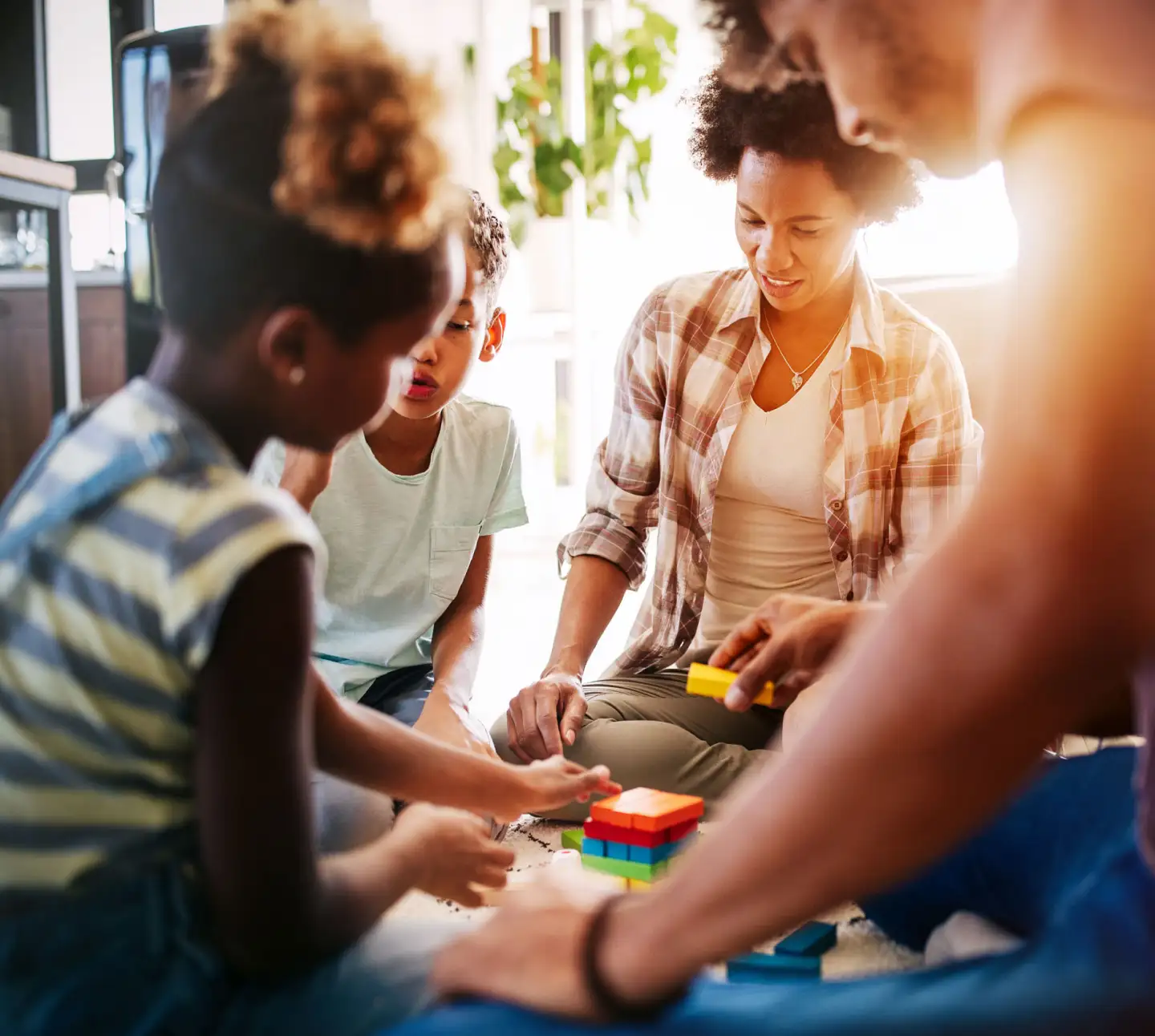 A family sitting around a toy and playing